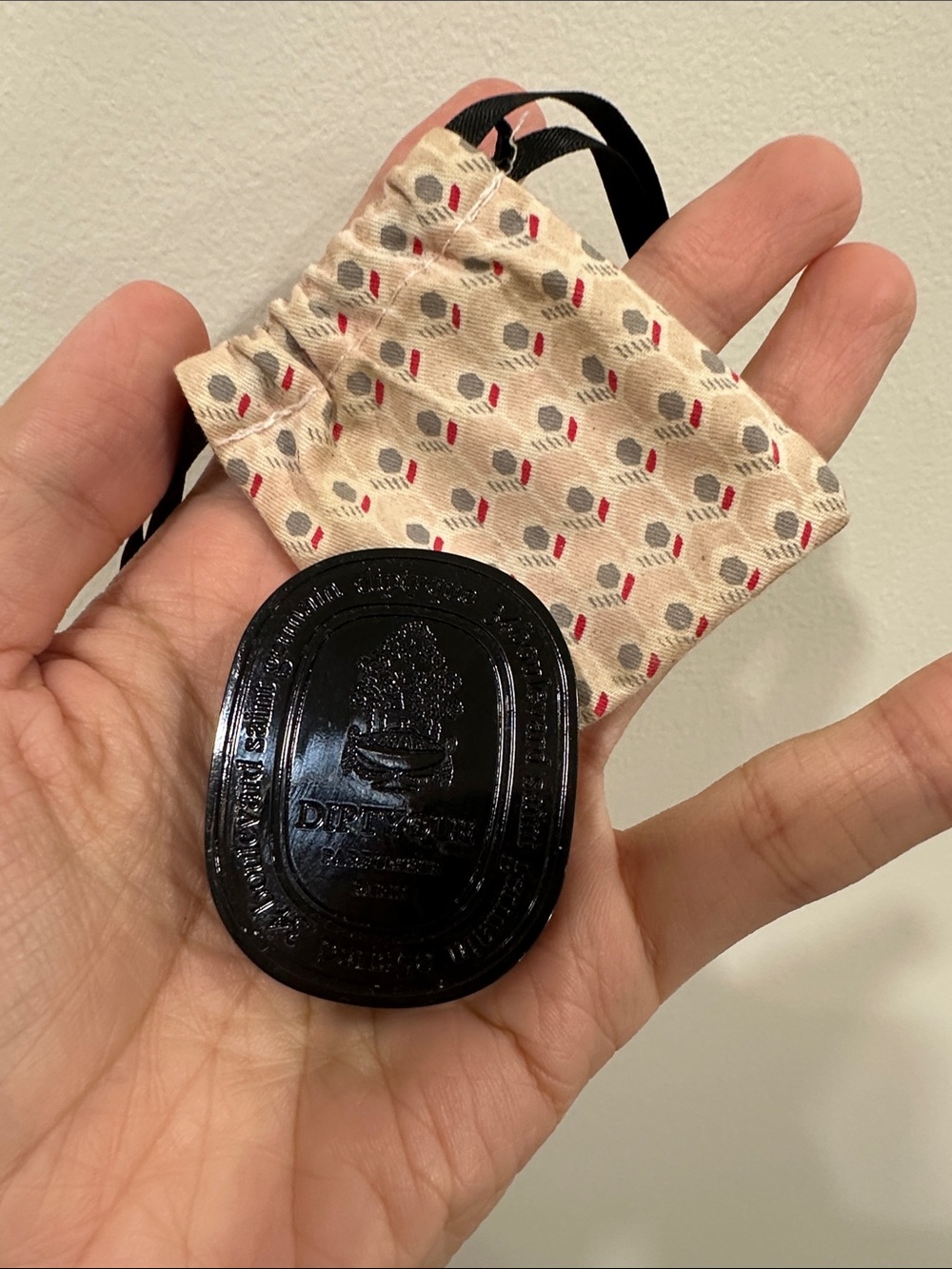 diptyque Black Oval Logo Token with Patterned Pouch